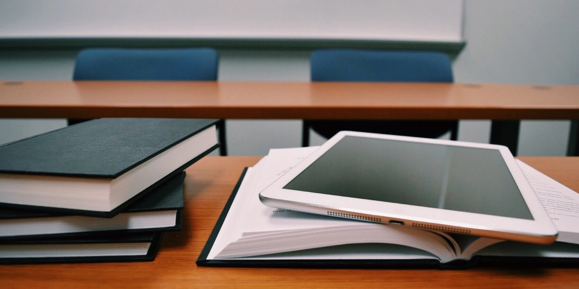 A tablet on a stack of books