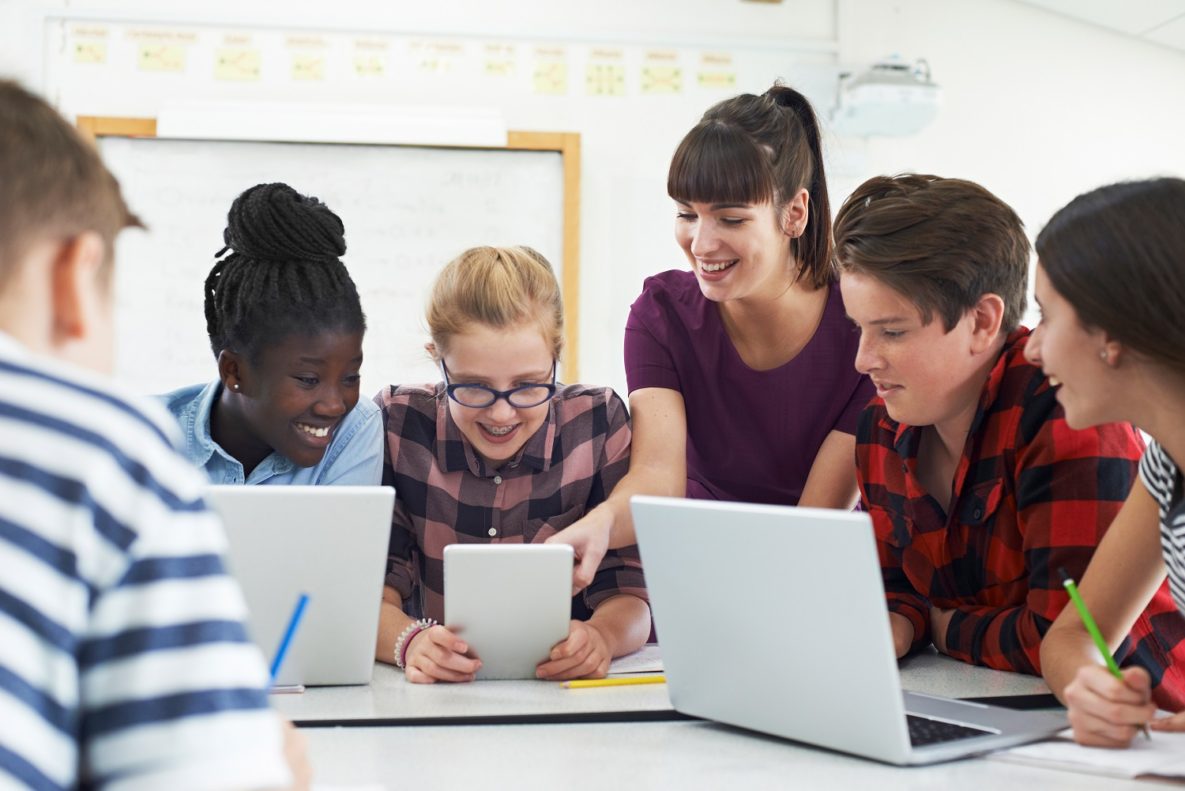 Une enseignante et ses élèves utilisent des ordinateurs portables en classe