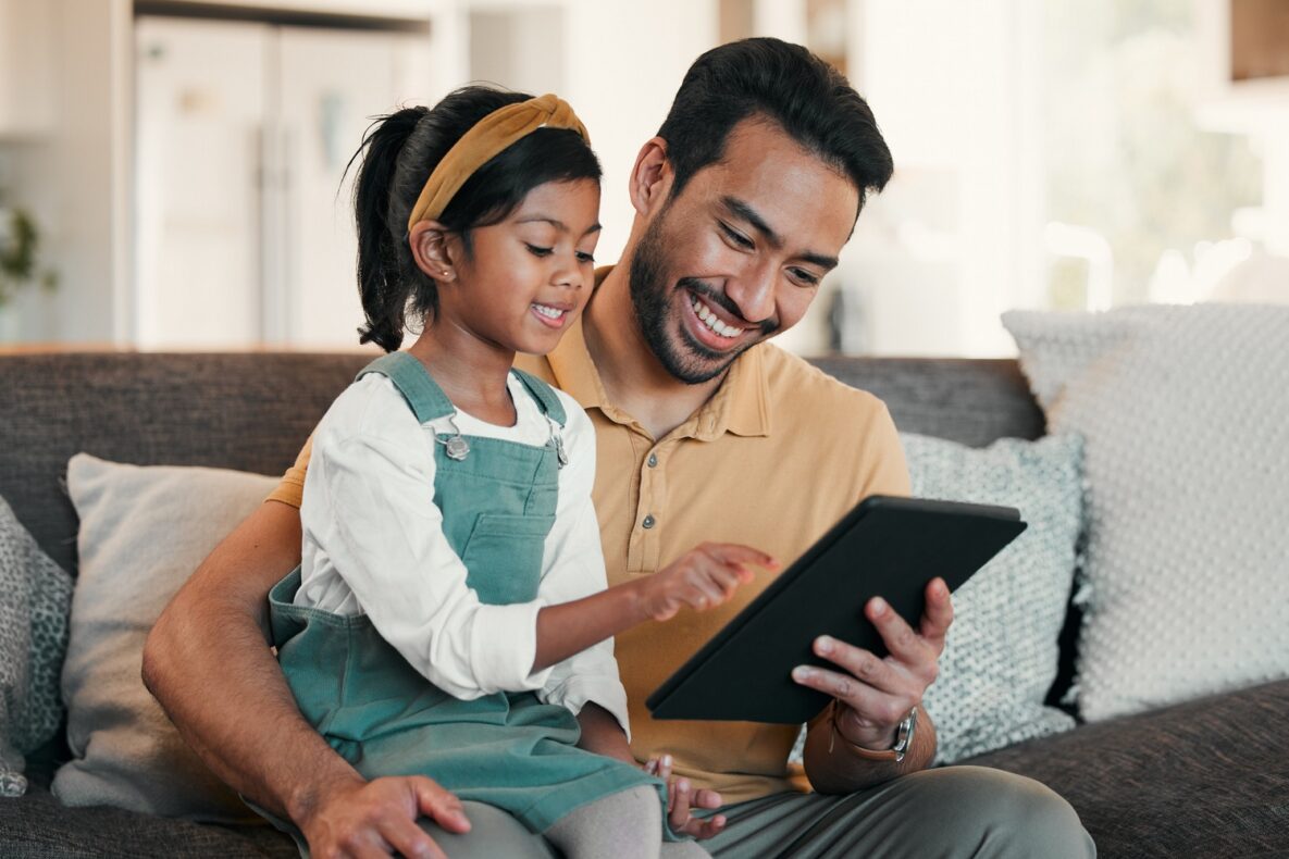 Father, girl and child with tablet on sofa for online games, reading ebook story and educational media at home. Man, dad and happy kid streaming cartoon, movies and digital technology in living room